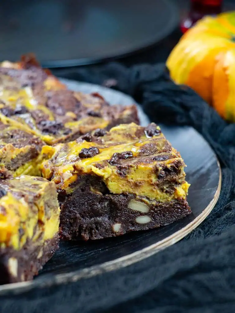 the layering of cashews brownie and pumpkin cheesecake